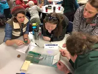 Workshop participants explore hands-on activity to understand tsunami inundation factors.